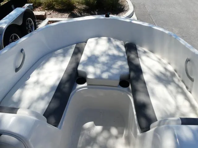 Slide: The Image of 2019 Bayliner Element E18 boat interior with cushioned seating and cup holders. - 9