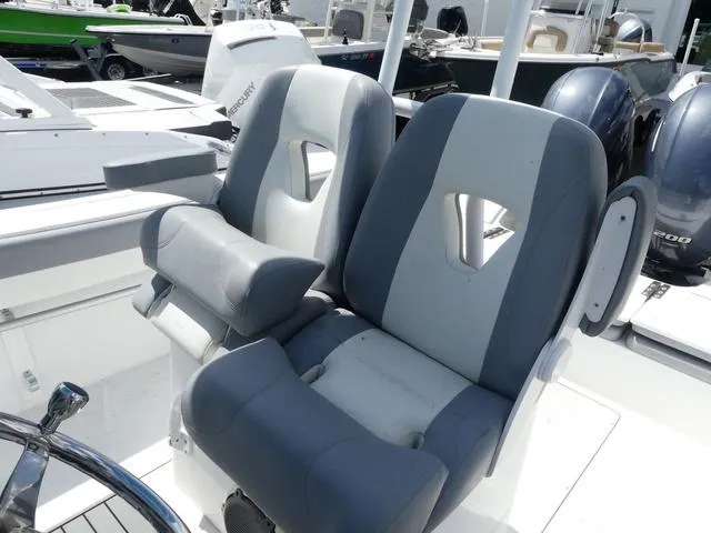 Slide: The Image of 2021 Release 240 RX boat seats, gray and white, with modern design in a marina setting. - 10