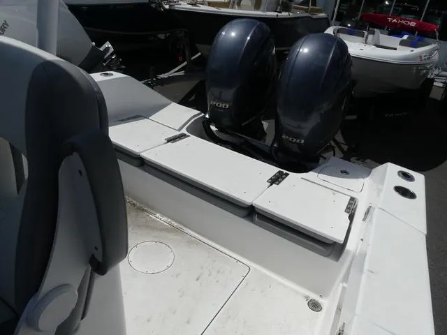 Slide: The Image of 2021 Release 240 RX boat with dual outboard engines, white seating, and storage compartments. - 11
