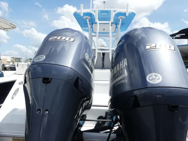 Slide: The Image of Twin Yamaha 200 outboard motors on a 2021 Release 240 RX boat under a blue sky. - 5