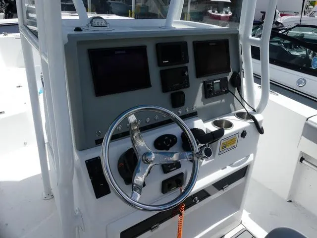 Slide: The Image of 2021 Release 240 RX boat console with steering wheel and electronic displays. - 9