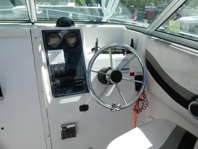 Slide: The Image of Interior cockpit of 2002 Seaswirl Striper 2301 boat with steering wheel and control panel. - 10