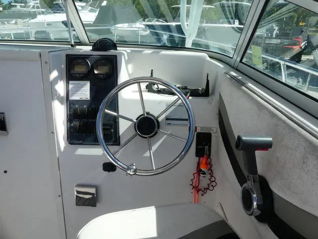Slide: The Image of 2002 Seaswirl Striper 2301 boat helm with steering wheel and control panel. - 11