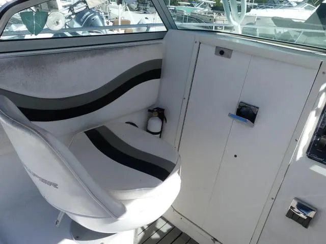 Slide: The Image of 2002 Seaswirl Striper 2301 boat interior with seating and control panel. - 12