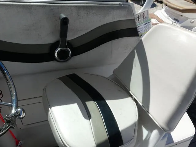 Slide: The Image of 2002 Seaswirl Striper 2301 boat interior with white and black seating. - 14