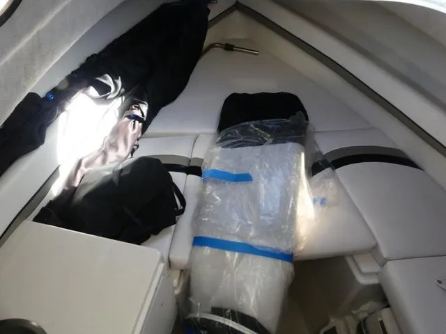 Slide: The Image of 2002 Seaswirl Striper 2301 cabin interior with seating and storage. - 17