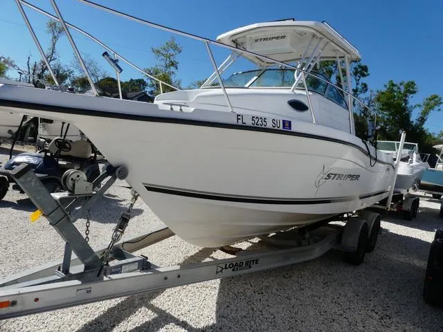 Slide: The Image of 2002 Seaswirl Striper 2301 boat on trailer, parked outdoors. - 3