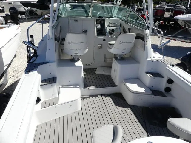 Slide: The Image of 2002 Seaswirl Striper 2301 boat interior with seating and steering console. - 9