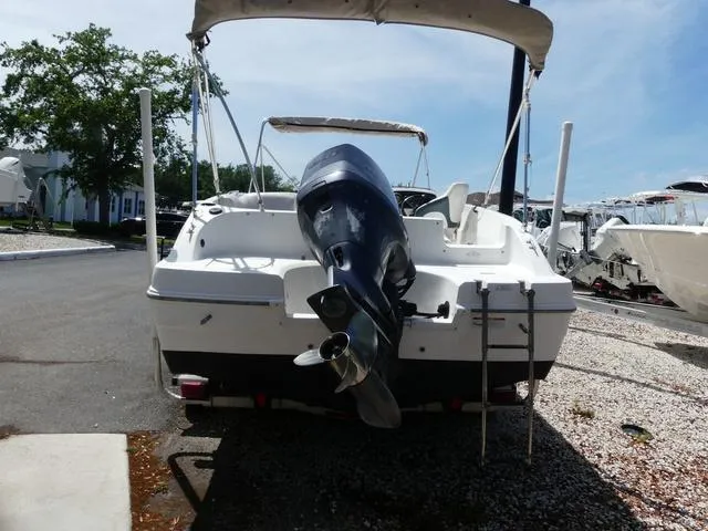 Slide: The Image of 2014 Hurricane SS 188 OB boat with outboard motor, parked on a sunny day. - 5