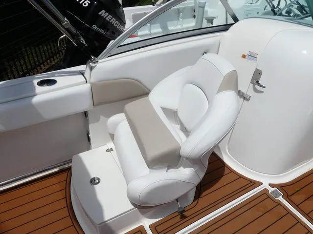 Slide: The Image of 2019 Robalo R207 boat interior with white cushioned seating and teak flooring. - 12