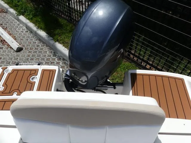 Slide: The Image of 2019 Robalo R207 boat with outboard motor and teak-style decking. - 14