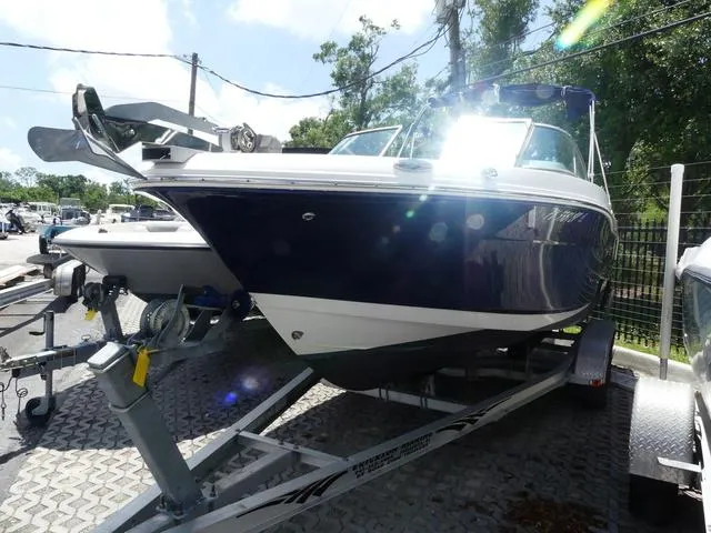 Slide: The Image of 2019 Robalo R207 boat on trailer, parked outdoors, sunny day. - 3