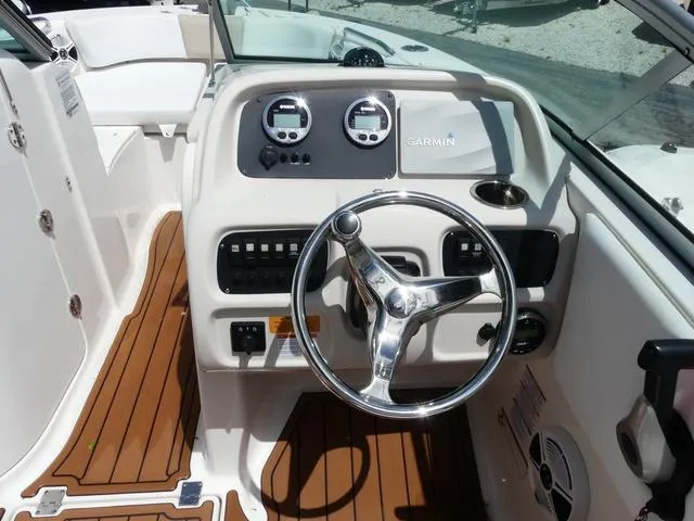 Slide: The Image of 2019 Robalo R207 boat dashboard with steering wheel and Garmin navigation system. - 8