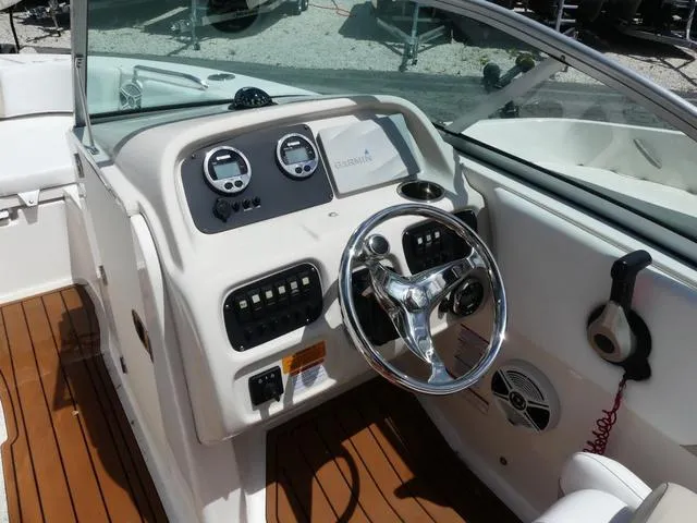 Slide: The Image of 2019 Robalo R207 boat dashboard with steering wheel and control panel. - 9