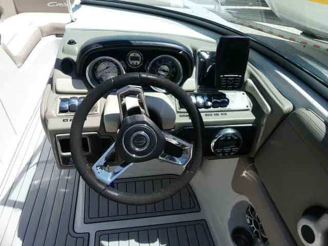 Slide: The Image of 2018 Crownline E23 XS boat dashboard with steering wheel and control panel. - 10