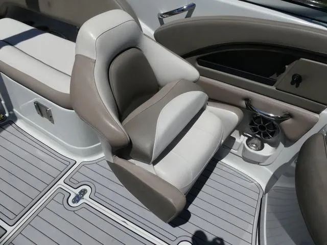 Slide: The Image of 2018 Crownline E23 XS boat interior with cushioned seating and cup holder. - 13