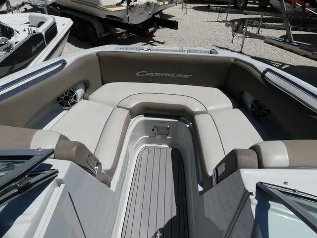 Slide: The Image of 2018 Crownline E23 XS boat interior with cushioned seating and speakers. - 15