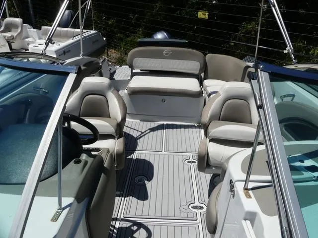 Slide: The Image of 2018 Crownline E23 XS boat interior with seating and helm, featuring sleek design and modern amenities. - 16