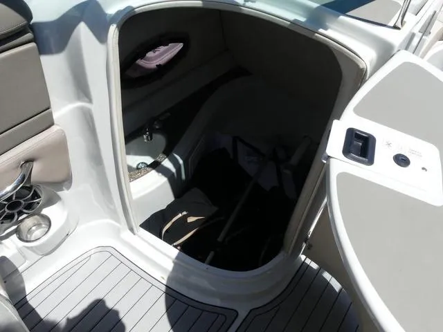 Slide: The Image of Interior cabin of 2018 Crownline E23 XS boat, featuring storage and seating area. - 17