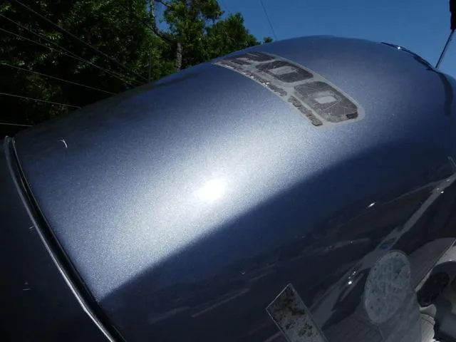 Slide: The Image of Outboard motor on a 2018 Crownline E23 XS boat under clear blue sky. - 7
