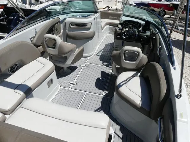 Slide: The Image of 2018 Crownline E23 XS boat interior with beige seating and modern dashboard. - 8