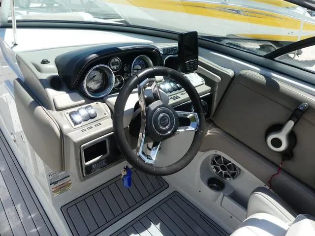 Slide: The Image of 2018 Crownline E23 XS boat dashboard with steering wheel and control panel. - 9