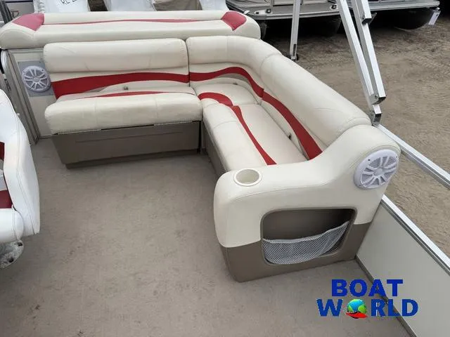 Slide: The Image of 2006 Sun Tracker Party Barge 20 Pontoon seating with red and beige upholstery, cup holder, and speaker. - 23