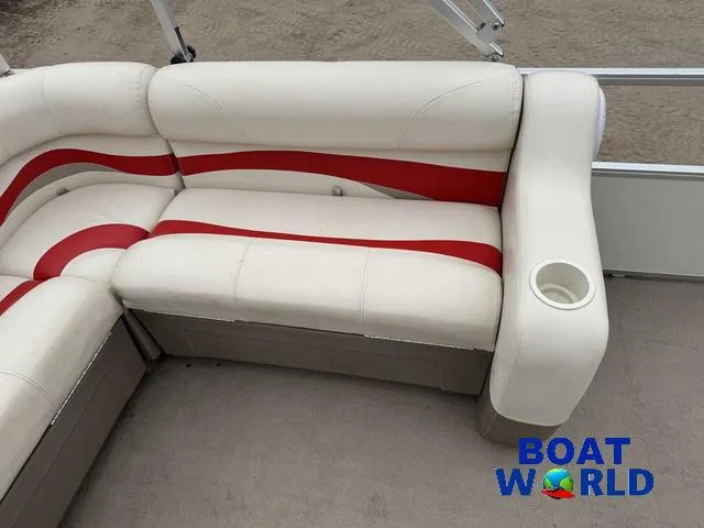 Slide: The Image of 2006 Sun Tracker Party Barge 20 Pontoon seating with red and white upholstery and cup holder. - 26