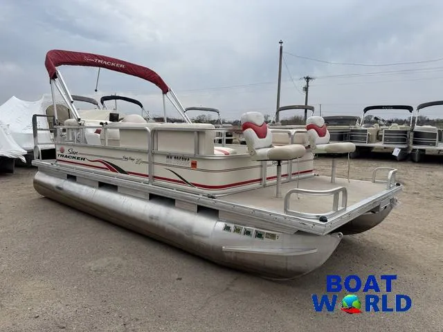Slide: The Image of 2006 Sun Tracker Party Barge 20 Pontoon with red canopy in a boat dealership. - 34
