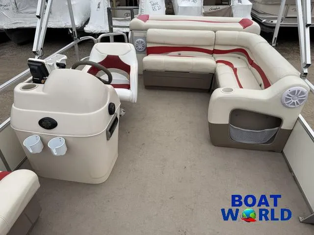 Slide: The Image of 2006 Sun Tracker Party Barge 20 Pontoon with beige and red seating, steering console, and cup holders. - 4