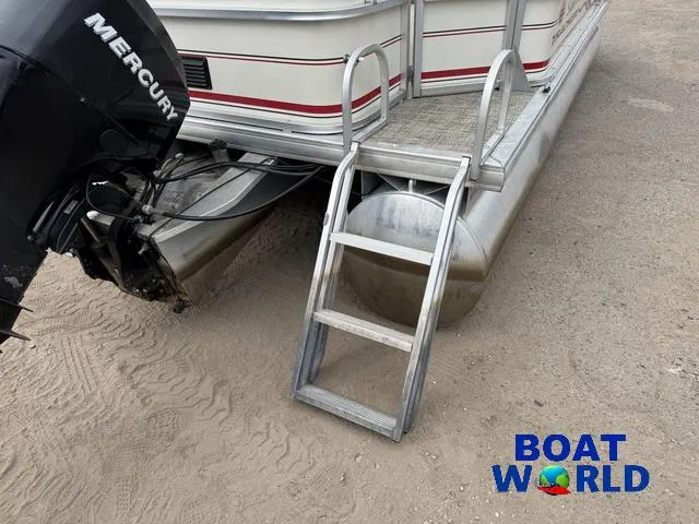 Slide: The Image of 2006 Sun Tracker Party Barge 20 Pontoon with Mercury engine and ladder on sandy ground. - 7