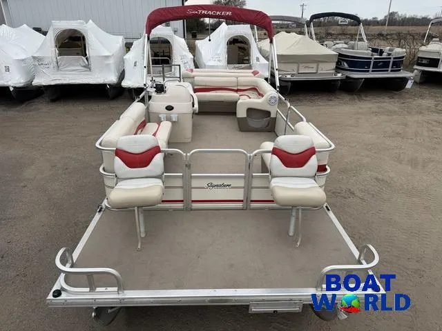 Slide: The Image of 2006 Sun Tracker Party Barge 20 Pontoon with red and white seating, parked outdoors. - 8