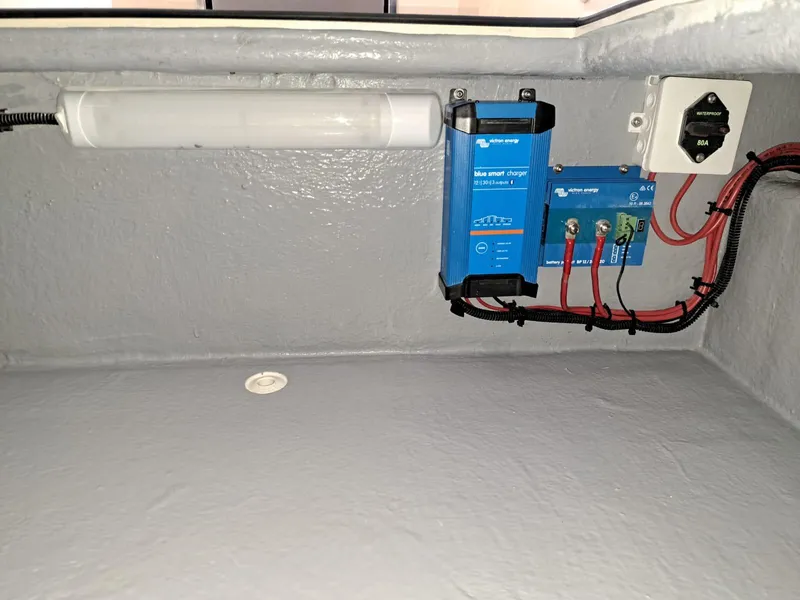 Slide: The Image of Electrical setup inside Lilybaeum Levanzo 25 Lounge Deck, featuring a smart charger and wiring. - 31