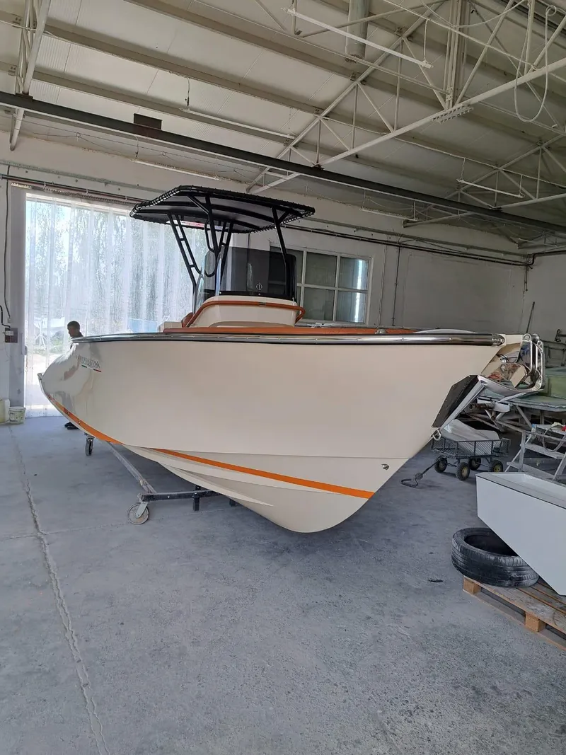 Slide: The Image of 2025 Lilybaeum Levanzo 25 Lounge Deck boat in a warehouse setting. - 6