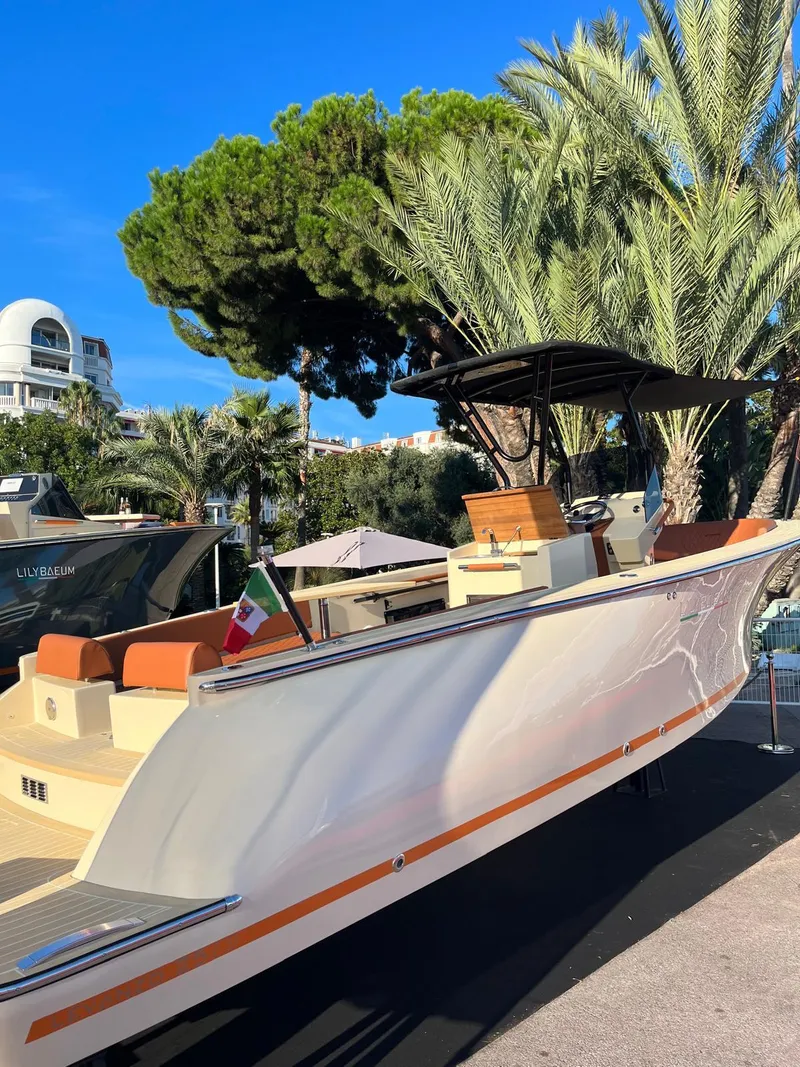 Slide: The Image of 2025 Lilybaeum Levanzo 25 Lounge Deck boat, sleek design, docked near palm trees. - 7