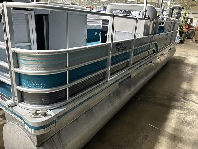 Slide: The Image of 1994 Harris-Kayot Heritage 2400 pontoon boat in a warehouse setting. - 11