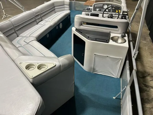 Slide: The Image of 1994 Harris-Kayot Heritage 2400 boat interior with blue carpet and gray seating. - 12