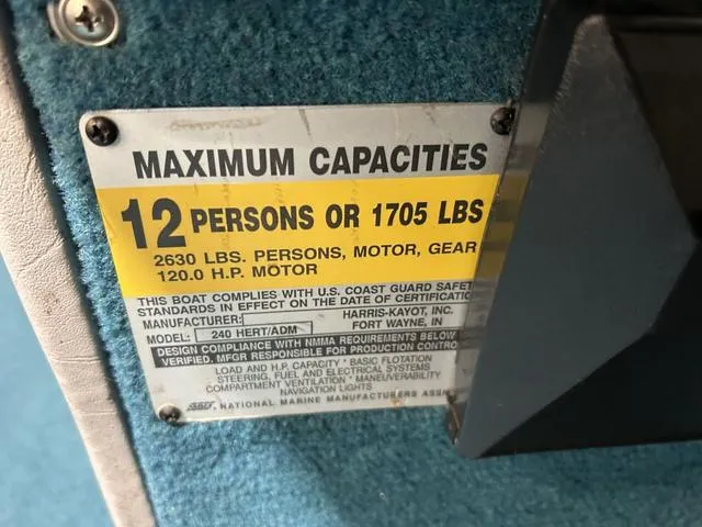 Slide: The Image of Maximum capacity label on 1994 Harris-Kayot Heritage 2400 boat, 12 persons or 1705 lbs. - 14