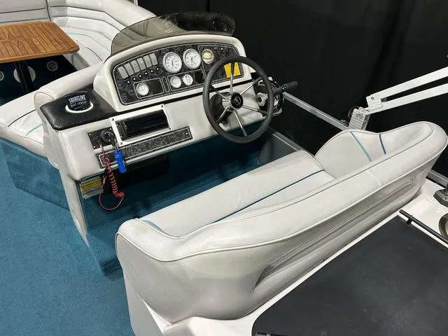 Slide: The Image of 1994 Harris-Kayot Heritage 2400 boat interior with steering wheel and dashboard controls. - 18