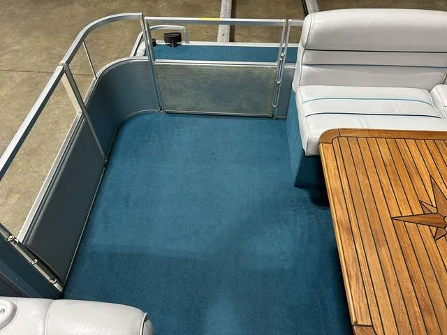 Slide: The Image of 1994 Harris-Kayot Heritage 2400 boat interior with blue carpet and wooden table. - 24