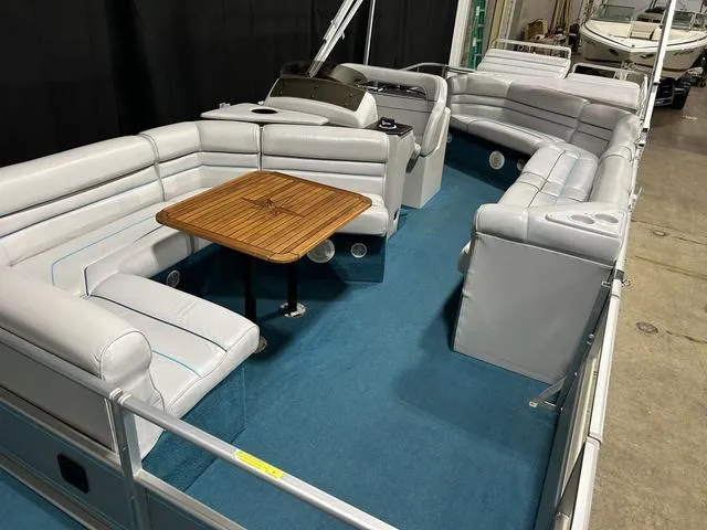 Slide: The Image of 1994 Harris-Kayot Heritage 2400 pontoon boat with spacious seating and wooden table. - 27