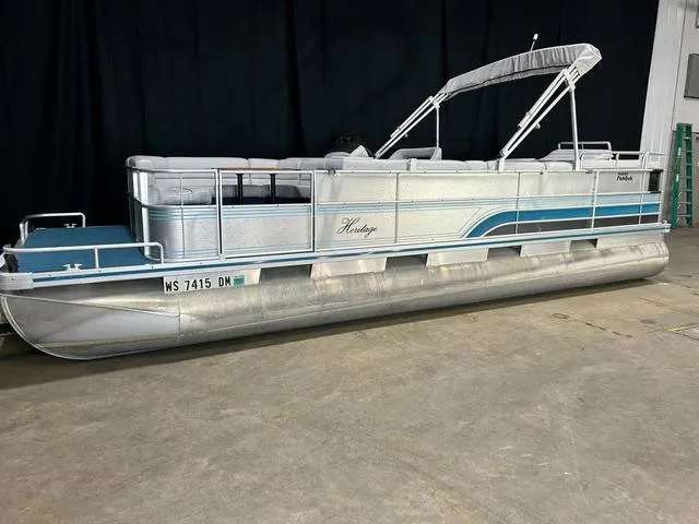 Slide: The Image of 1994 Harris-Kayot Heritage 2400 pontoon boat in a showroom setting. - 3