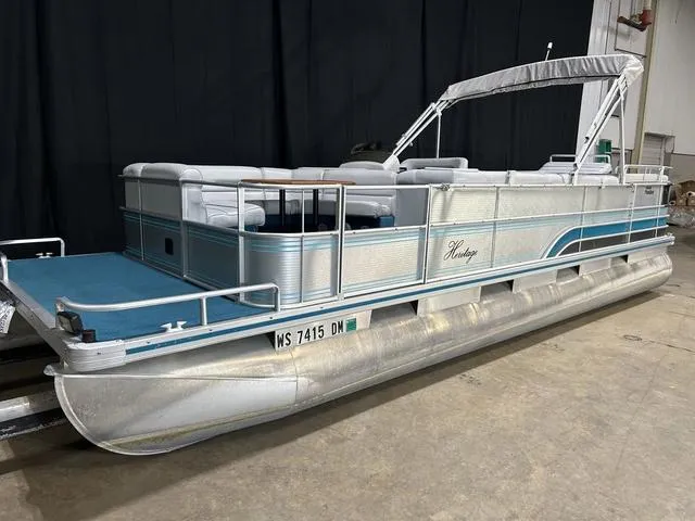 Slide: The Image of 1994 Harris-Kayot Heritage 2400 pontoon boat in a warehouse setting. - 4