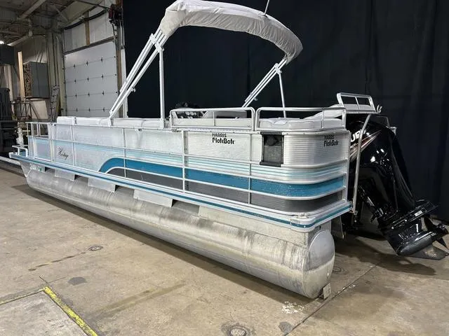 Slide: The Image of 1994 Harris-Kayot Heritage 2400 pontoon boat in a warehouse setting. - 7