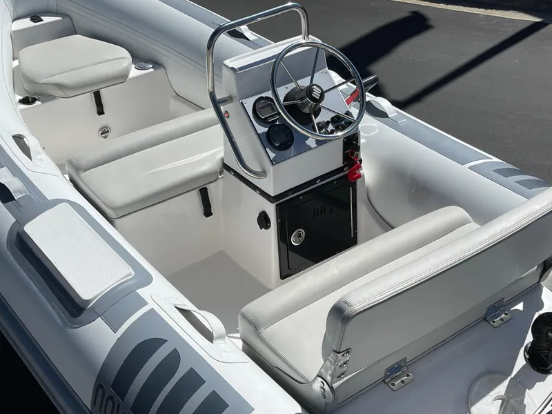 Slide: The Image of 2007 Novurania Deluxe 400 boat interior with steering console and seating. - 15
