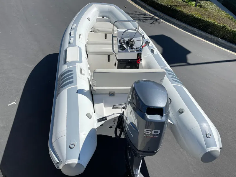 Slide: The Image of 2007 Novurania Deluxe 400 inflatable boat with outboard motor on a road. - 16