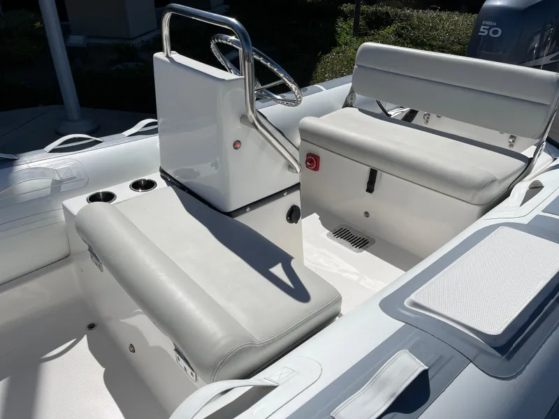Slide: The Image of 2007 Novurania Deluxe 400 boat interior with white seating and steering console. - 3