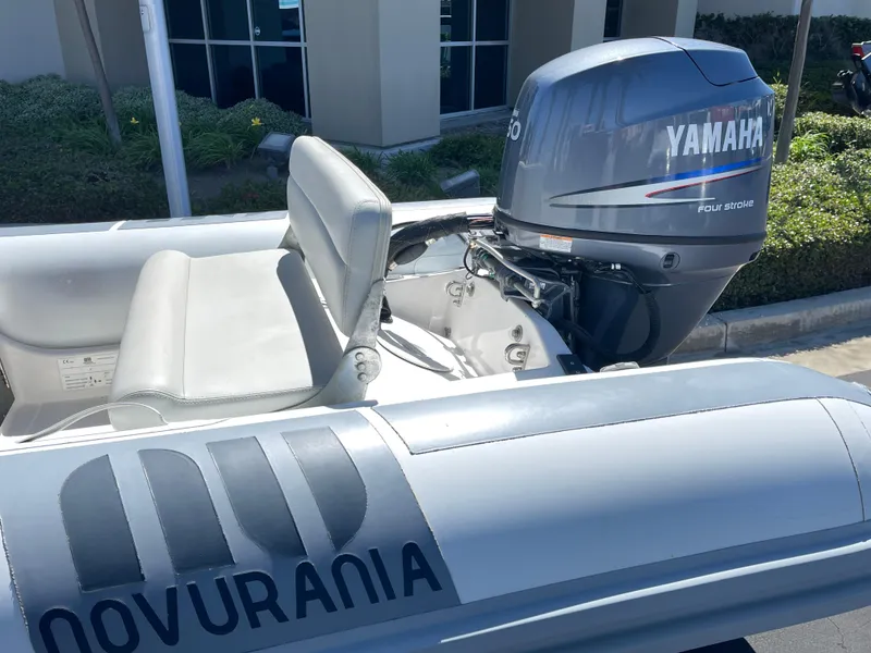 Slide: The Image of 2007 Novurania Deluxe 400 boat with Yamaha outboard motor, parked outdoors. - 5