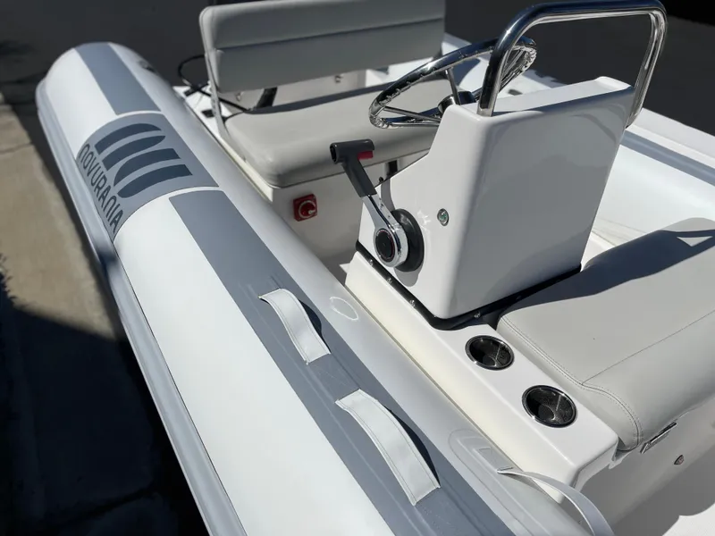 Slide: The Image of 2007 Novurania Deluxe 400 boat interior with steering console and seating. - 7