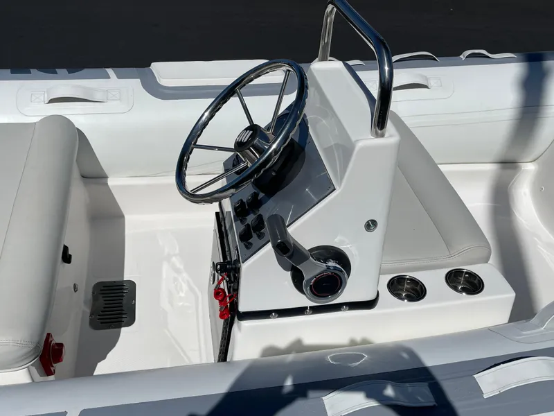 Slide: The Image of 2007 Novurania Deluxe 400 boat interior with steering wheel and controls. - 8